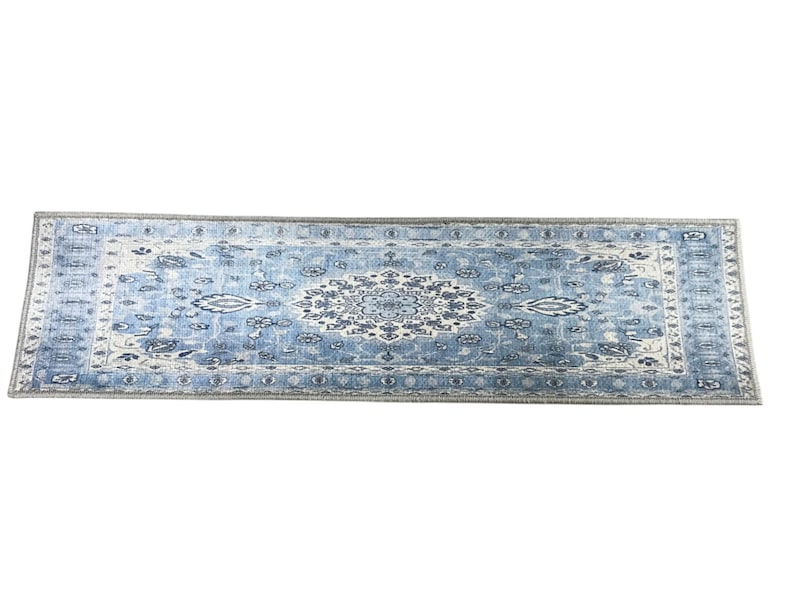 a large, blue and white rug with a floral pattern.