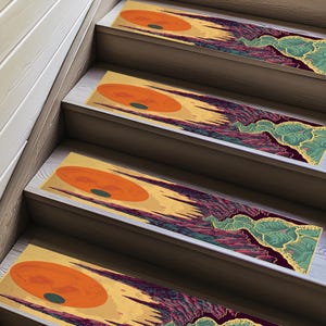 May include: Set of four non-slip stair treads with a colorful abstract design featuring a large orange circle with a smaller green circle inside. The design is reminiscent of a sunset or sunrise over a mountain range.
