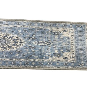 a blue and white patterned rug or carpet with intricate designs and patterns.
