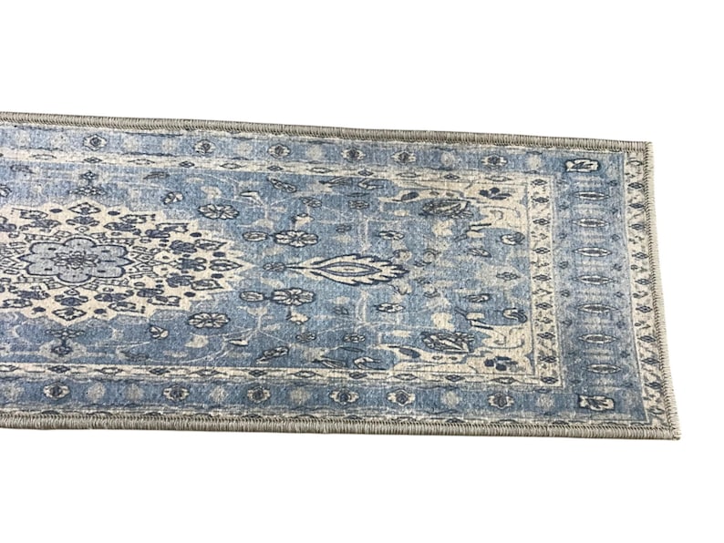 a blue and white patterned rug or carpet with intricate designs and patterns.