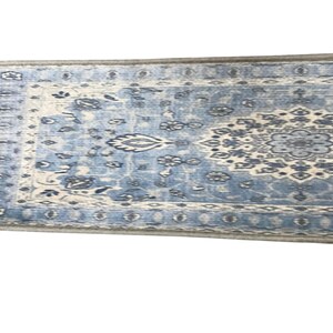 a blue and white patterned rug or carpet with intricate designs and patterns.