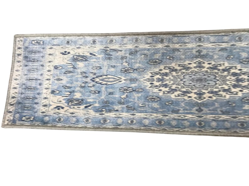 a blue and white patterned rug or carpet with intricate designs and patterns.