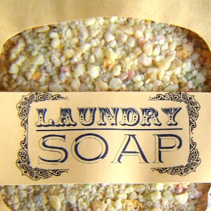May include: Close-up of a bag of laundry soap. The soap is white with small, colorful flecks. The bag has a label that reads "Laundry Soap" in a decorative font.