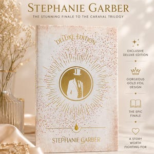 May include: A book cover for "Deluxe Edition" by Stephanie Garber. The cover is primarily white with gold accents and text. The title and author's name are in gold. The cover features a gold illustration of a person in a suit and top hat.