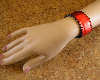 Metallic Sangria Leather Cuff Bracelet with black lacing, 7"  x 1 1/4" wide, lined with soft cream cowhide leather