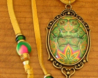 Hemp Green Man, 30 mm x 40 mm glass dome pendant set in a brass frame with a 32" x 1/8" beaded adjustable gold deerskin leather cord