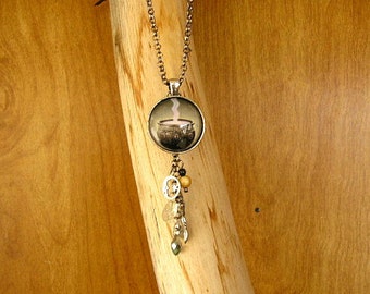 Caldron 1" glass cabochon pendant with crystal and glass beads and charms, set in a silver bezel with a 24" rolo chain