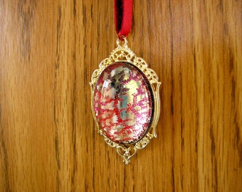 Looking glass, Mirror, Red glitter necklace, 30 mm x 40 mm glass dome set in a silver frame with a beaded 30" long leather cord