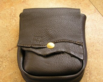 Dark brown Leather hip bag 5" x 6" x 2" with brass snap, one inside pocket and  a loop for your belt