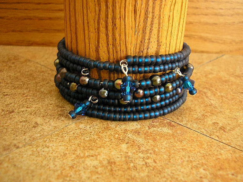 Montana Blue Blue Czech glass seed beads and black pearls on memory wire bracelet 60mm across 3 bracelets with a total of 9 wraps image 1
