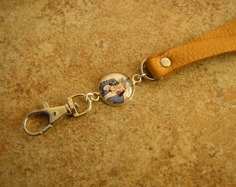 ID Lanyar, Uncle Sam, honey leather and charm lanyard, strap is 35" long with a charm and a spring clip.