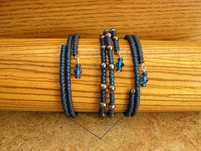 Montana Blue Blue Czech glass seed beads and black pearls on memory wire bracelet 60mm across 3 bracelets with a total of 9 wraps image 2