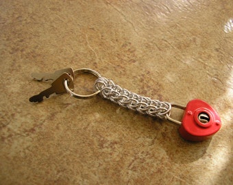Heart Lock chainmail keychain, 3" long with a 7/8" keyring, working lock is 3/4" wide with two keys