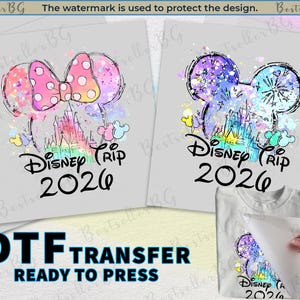 May include: DTF transfer featuring a colorful Disney design with a castle, mouse ears, and the text "Disney Trip 2026". The design includes a pink bow with white polka dots. Ready to press.