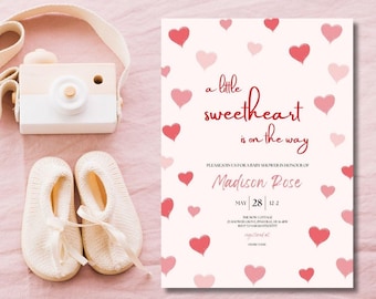May include: A white baby shower invitation with a pink and red heart pattern. The text reads "a little sweetheart is on the way" and "Please join us for a baby shower in honor of Madison Rose, May 28, 122".