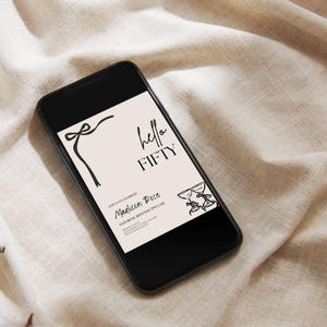 May include: A black smartphone displays a digital invitation with the text "hello FIFTY." The invitation features a bow, two champagne glasses, and the name "Madison Rose." The background is a light beige color.