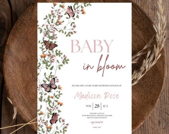 May include: A baby shower invitation with a floral design featuring butterflies and the text "BABY in bloom" in pink and burgundy. The invitation is for Madison Rose and the date is May 28th.