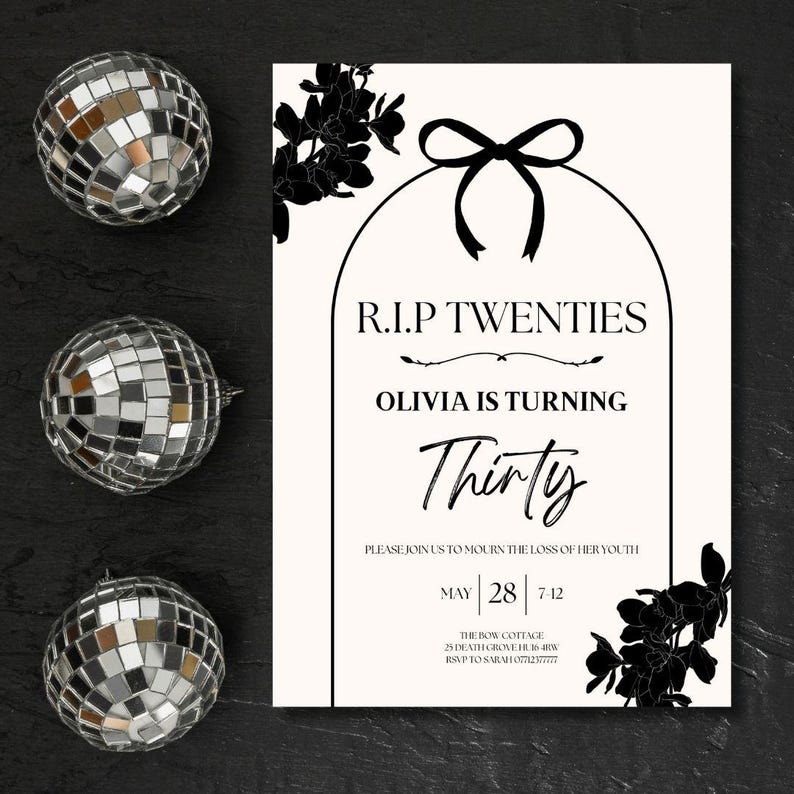 May include: A party invitation with the text "R.I.P Twenties, Olivia is Turning Thirty" in black font. The invitation is decorated with black floral accents and a black bow. Three silver disco balls are on the left side of the invitation.