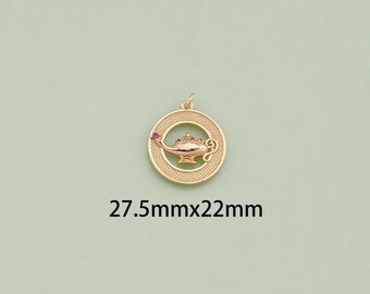May include: Gold-toned pendant charm featuring a genie lamp design with a red gemstone. The charm is 27.5mm by 22mm.