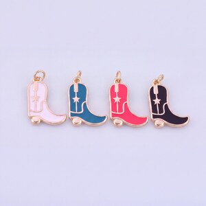 May include: Four metal charms shaped like cowboy boots, each featuring a small star detail on the shaft and a jump ring at the top. The boots are finished in enamel colors of light pink, teal, bright red, and black, all with gold-toned metal edges.
