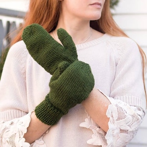 May include: A pair of green knitted mittens with a fold-over cuff. The mittens are made of a soft, warm yarn and are perfect for keeping your hands warm in the winter.