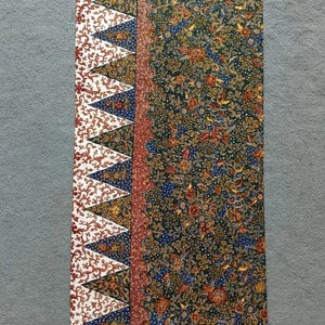 May include: A rectangular fabric panel with a colourful floral pattern. The fabric has a border with a white background and a red, blue and white geometric pattern.