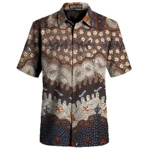 May include: Short-sleeved button-down shirt with a batik pattern. The shirt features a brown, cream, and navy blue color scheme with floral and leaf motifs. The collar has a label that reads "26 Batik Madura".
