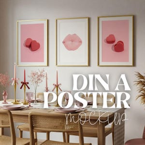 May include: Three framed art prints with gold frames hang above a dining table. The prints feature a pair of red heart-shaped objects, a pink lip, and another pair of heart-shaped objects. The table is set with pink plates and candles.
