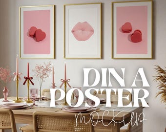 May include: Three framed art prints with gold frames hang above a dining table. The prints feature a pair of red heart-shaped objects, a pink lip, and another pair of heart-shaped objects. The table is set with pink plates and candles.