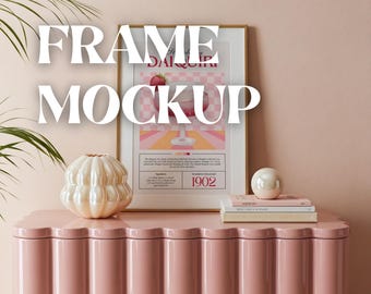 May include: A pink dresser with a wavy design and a framed poster with a checkered background and the text "The History of the Daiquiri 1902". There is a white ceramic vase and a white orb on top of the dresser.
