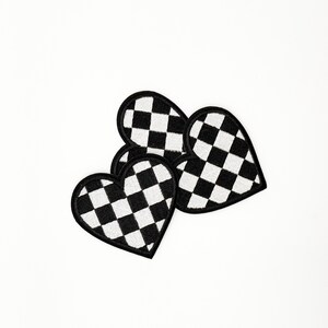 May include: Three black and white checkered heart-shaped patches.