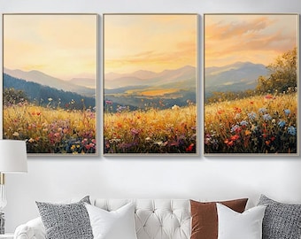 May include: A three-panel canvas print depicting a landscape scene with a field of wildflowers in the foreground and rolling hills in the background. The sky is a soft orange and yellow, suggesting a sunset or sunrise.