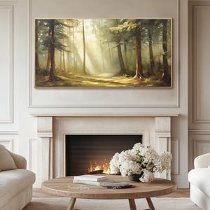 May include: A painting of a forest scene with sunlight streaming through the trees. The painting is in a gold frame and is hanging on a wall above a fireplace.