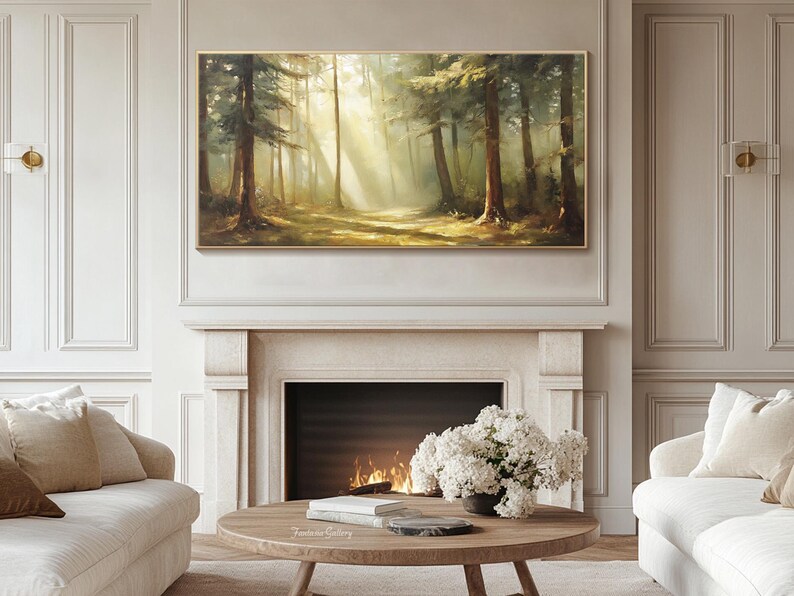 May include: A painting of a forest scene with sunlight streaming through the trees. The painting is in a gold frame and is hanging on a wall above a fireplace.