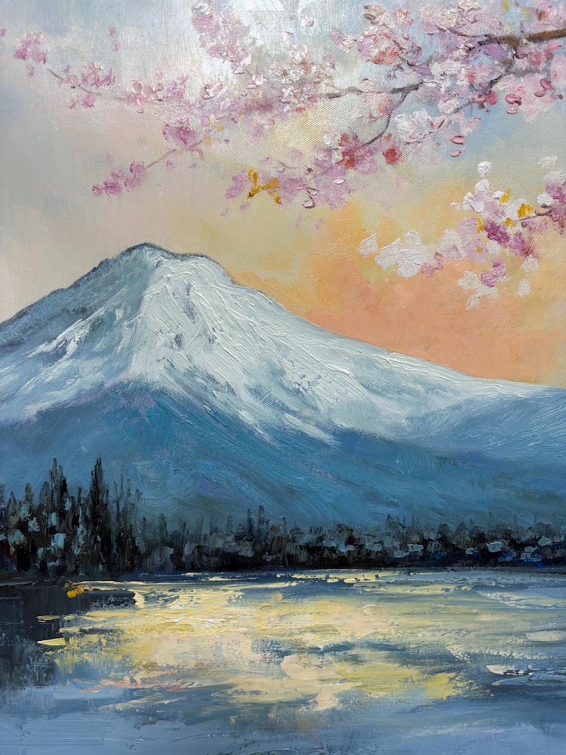May include: A painting of a snow-capped mountain with a lake in the foreground. The sky is a soft blue with pink and white blossoms from a cherry tree in the upper right corner.