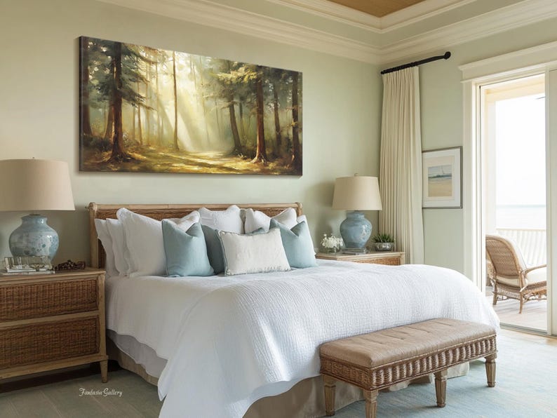 May include: A white bed with a light blue and white patterned comforter and pillows. The bed is in a bedroom with a large window and a painting of a forest scene above the headboard.