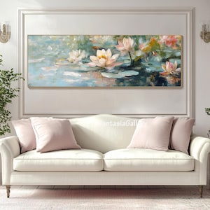 May include: A painting of pink and white water lilies in a pond. The lilies are in bloom and the water is a light blue color. The painting is framed in a gold frame and is hanging on a white wall.