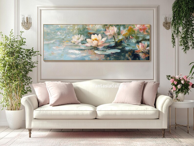 May include: A painting of pink and white water lilies in a pond. The lilies are in bloom and the water is a light blue color. The painting is framed in a gold frame and is hanging on a white wall.