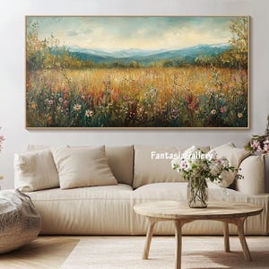 May include: A landscape painting with a field of wildflowers in the foreground, a forest in the middle ground, and mountains in the background. The painting is done in oil on canvas and has a warm, inviting color palette.