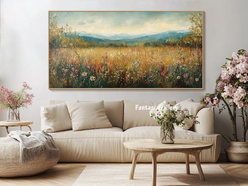 May include: A landscape painting with a field of wildflowers in the foreground, a forest in the middle ground, and mountains in the background. The painting is done in oil on canvas and has a warm, inviting color palette.