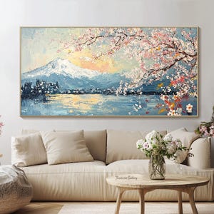 May include: A painting of a mountain range with a lake in the foreground. The mountain range is covered in snow and the lake is reflecting the sky. There are pink cherry blossoms in the foreground.