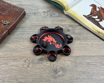 May include: Black dice rolling tray with a red dragon design and six compartments for dice. The tray is made of a durable material and is perfect for tabletop gaming.