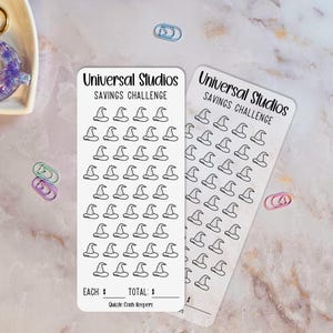 May include: Two white Universal Studios Savings Challenge stickers. Each sticker features a repeating pattern of witch hats. The text "Universal Studios Savings Challenge" is printed at the top. The bottom of the sticker has spaces for "EACH: $" and "TOTAL: $".