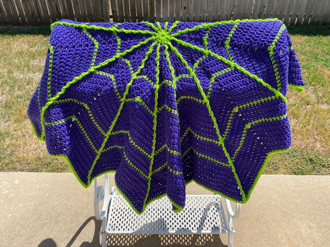 Purple and lime green spider web blanket for halloween decorating