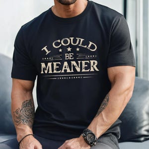 May include: A black t-shirt with a vintage-style graphic that reads "I could be meaner".