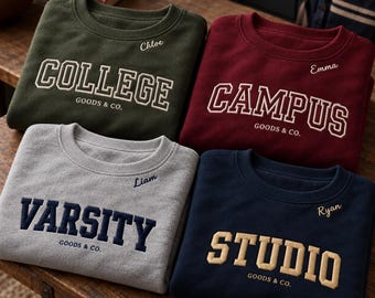 May include: Four crewneck sweatshirts in olive green, maroon, gray, and navy blue. Each features embroidered text: COLLEGE GOODS & CO. with Chloe, CAMPUS GOODS & CO. with Emma, VARSITY GOODS & CO. with Liam, and STUDIO GOODS & CO. with Ryan.