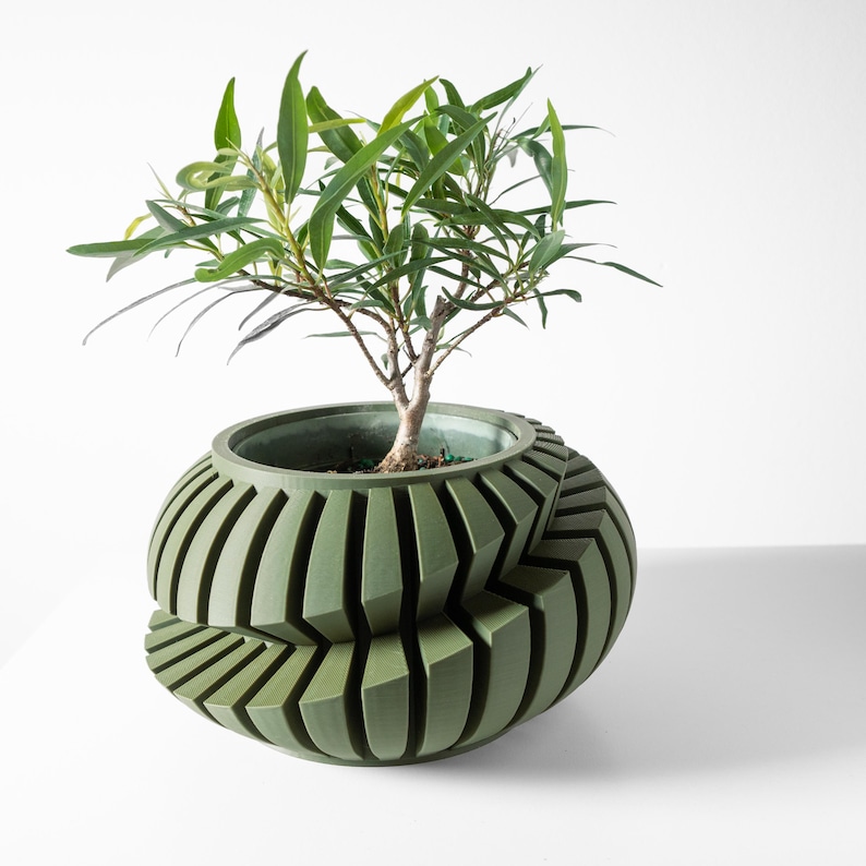 May include: A green, geometric planter with a plant growing out of it. The planter is made of a textured material and has a unique, modern design.