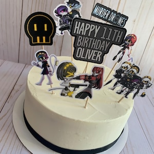 May include: A white cake with black frosting and a black ribbon. The cake is decorated with various cartoon characters and the text "Murder Drones", "Happy 11th Birthday Oliver".