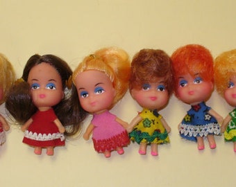 6 Tiny Dolls Charms as shown in picture