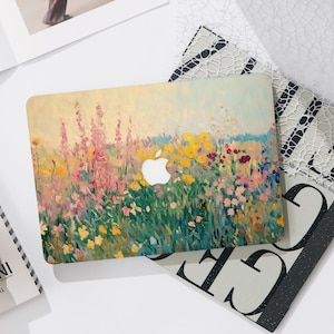 May include: A rectangular laptop hard shell case featuring an impressionistic oil painting style print of a vibrant wildflower meadow. The design displays tall pink stalks, yellow blossoms, and green foliage against a pale sky, with a central Apple logo cutout.